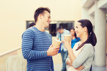 Image showing group of smiling students with paper coffee cups