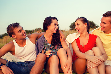 Image showing smiling friends in sunglasses on summer beach