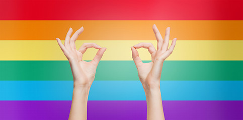 Image showing hands showing ok sign over rainbow background