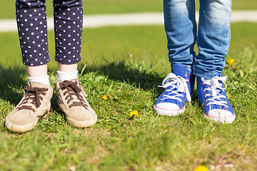 Image showing close up of kids legs in shoes on grass outdoors