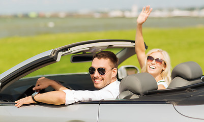 Image showing happy man and woman driving in cabriolet car