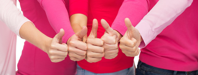 Image showing close up of women in pink shirts showing thumbs up