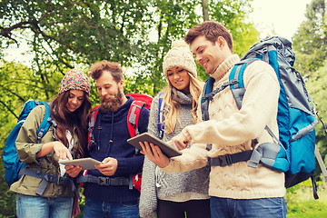 Image showing group of friends with backpacks and tablet pc