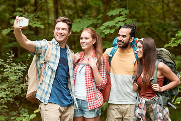 Image showing friends with backpack taking selfie by smartphone