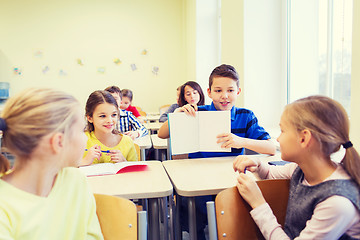 Image showing group of school kids writing test in classroom