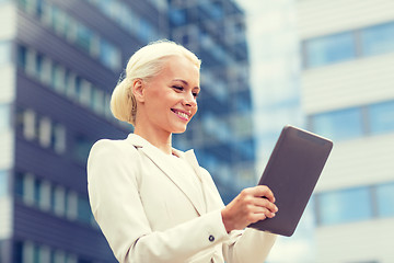 Image showing smiling businesswoman with tablet pc outdoors