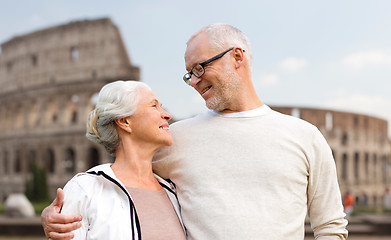 Image showing happy senior couple over coliseum in rome, italy