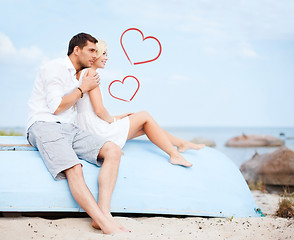 Image showing couple sitting on boat at sea side