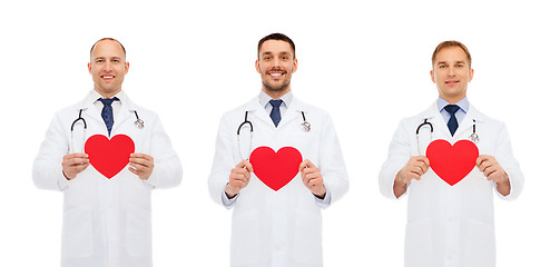 Image showing three smiling male doctors with red hearts
