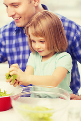 Image showing smiling father and little girl at kitchen