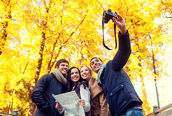 Image showing group of friends with map outdoors