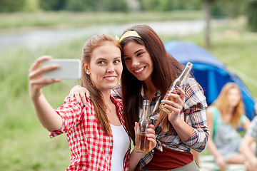 Image showing happy women taking selfie by smartphone at camping