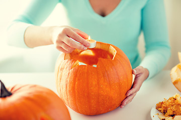 Image showing close up of woman with pumpkins at home