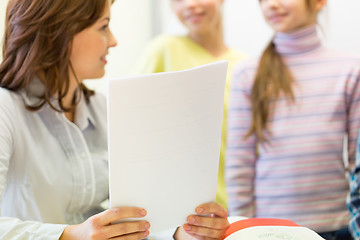 Image showing close up of school kids with teacher in classroom