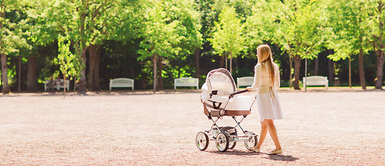Image showing happy mother with stroller in park
