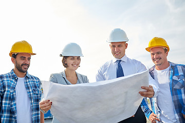 Image showing group of builders and architects with blueprint