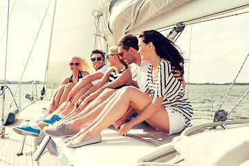 Image showing smiling friends sitting on yacht deck