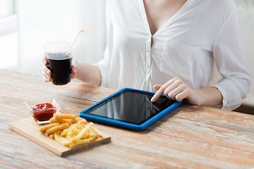 Image showing close up of woman with tablet pc and fast food