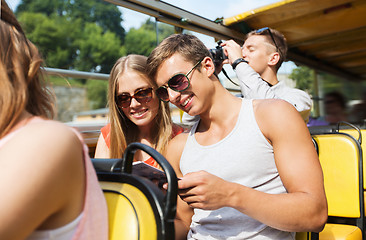 Image showing happy couple with guidebook traveling by tour bus