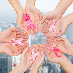 Image showing close up of hands with cancer awareness symbol