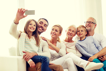 Image showing happy family with smartphone at home