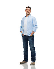 Image showing smiling man with hands in pockets