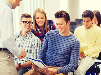 Image showing group of students and teacher with notebook