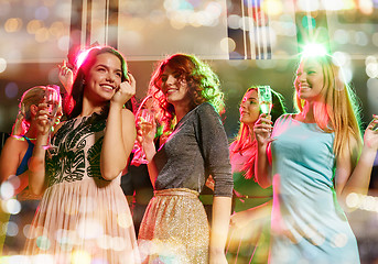 Image showing smiling friends with glasses of champagne in club