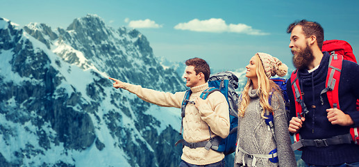 Image showing group of smiling friends with backpacks hiking