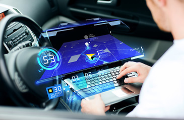 Image showing man using navigation on laptop computer in car