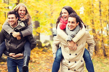 Image showing smiling friends having fun in autumn park