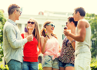 Image showing group of smiling friends with ice cream outdoors