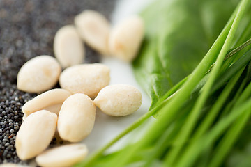 Image showing close up of peeled peanuts, greens and seeds