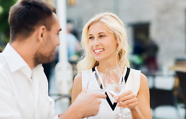 Image showing smiling couple drinking champagne at cafe