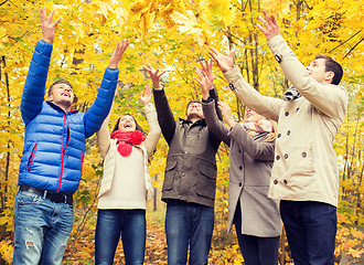 Image showing group of smiling men and women in autumn park