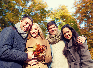 Image showing group of smiling men and women in autumn park