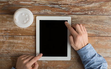 Image showing close up of male hands with tablet pc and coffee