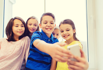 Image showing group of school kids taking selfie with smartphone