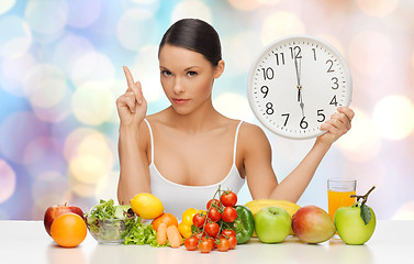 Image showing woman with healthy food and clock warning