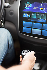 Image showing hand on gearshift and car navigation system