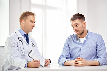 Image showing doctor and patient with cardiogram on clipboard