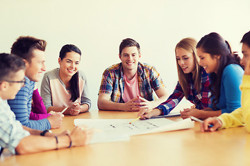 Image showing group of smiling students with blueprint