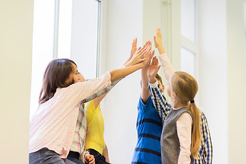 Image showing group of school kids making high five gesture