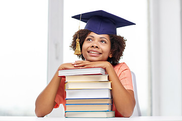 Image showing happy african bachelor girl with books at home