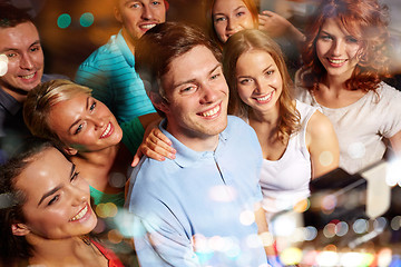 Image showing friends with smartphone taking selfie in club