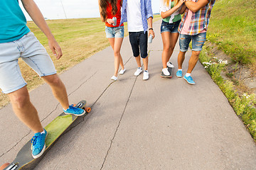 Image showing close up of friends with longboards and drinks