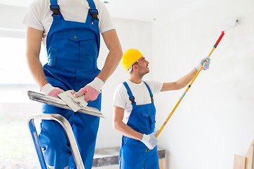 Image showing two builders with painting tools repairing room