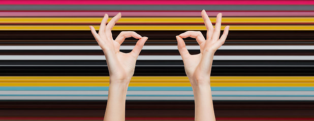 Image showing woman hands showing ok sign over blue sky