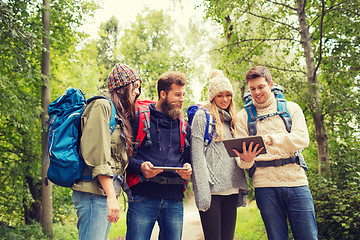 Image showing group of friends with backpacks and tablet pc