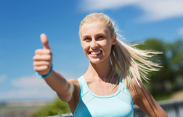 Image showing happy young woman exercising outside